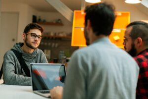 Tech interview concept. Young developer being interviewed for new role.