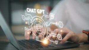 Generative AI enterprise concept. ChatGPT written in glowing white letters above laptop and graphic