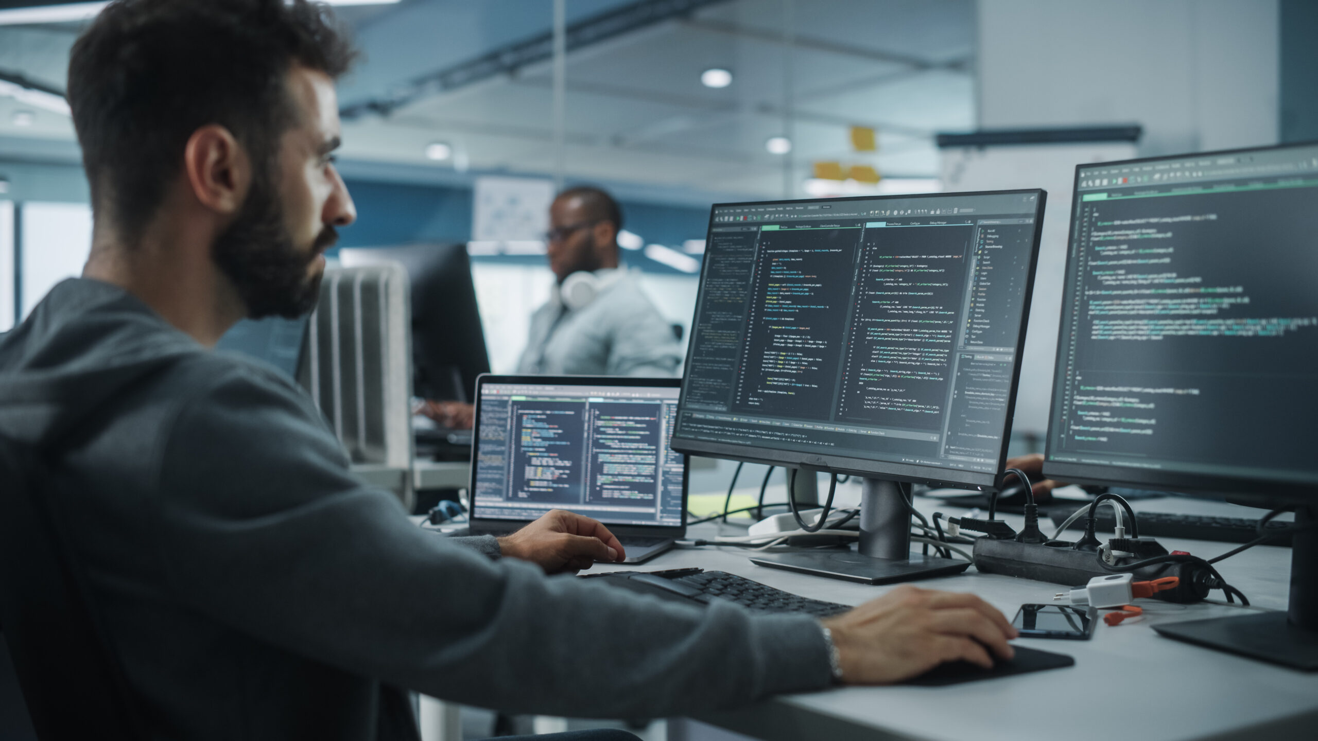 Kubernetes best tools concept. IT programmer works at station with multiple monitors